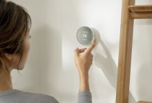 Person Adjusting Thermostat 1